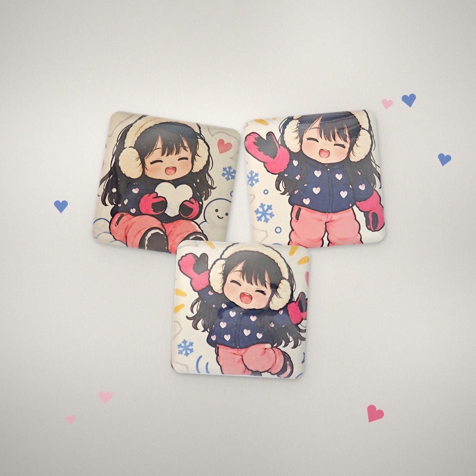 Three glossy custom cartoon magnets on linen